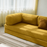 Primyhome Ginger Yellow corduroy convertible sofa bed in a sunlit living room with minimalist decor and boho wall art